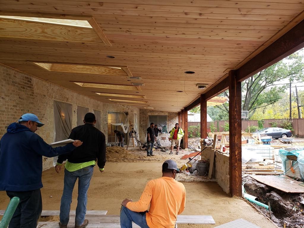 a group of construction workers are working on a building under construction .