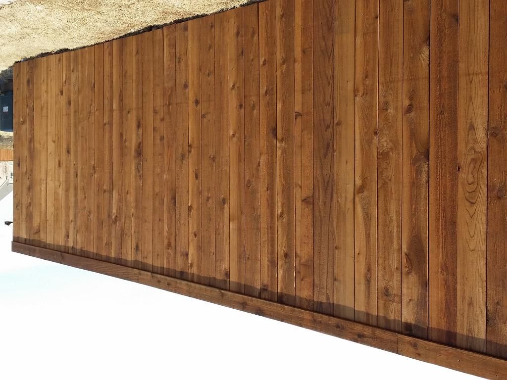 A wooden fence is sitting on top of a white surface.