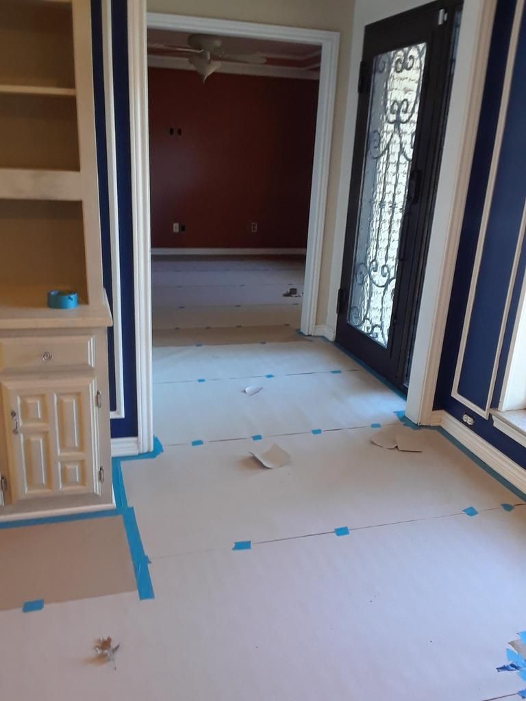 An empty room with blue walls and white cabinets