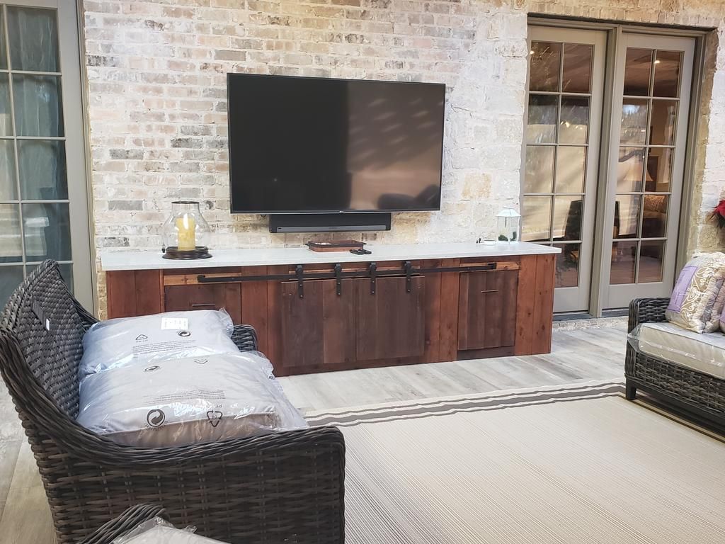 A living room with a large flat screen tv mounted on the wall.