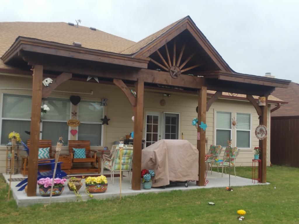 A house with a wooden porch and a grill