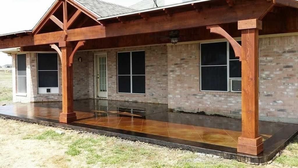 a brick house with a wooden covered porch