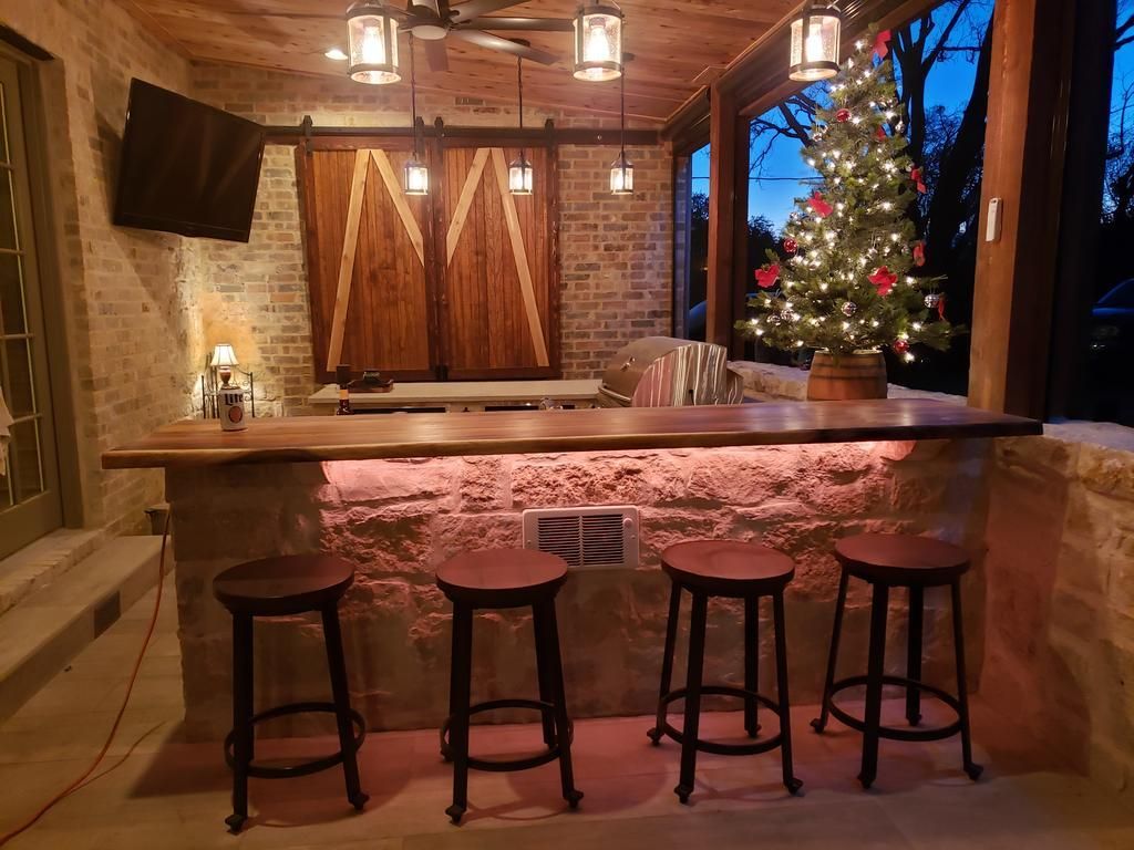 a man is standing in a kitchen with a christmas tree in the background