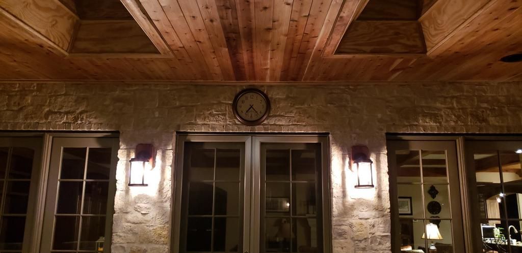 A house with a wooden ceiling and a clock on the wall.