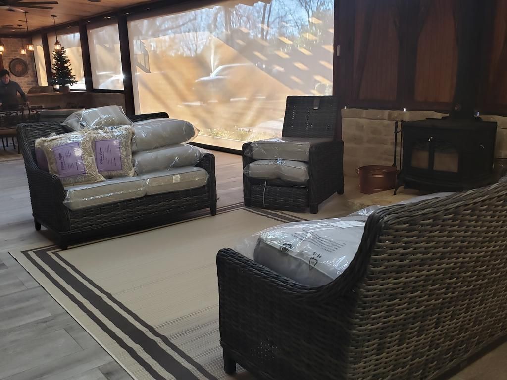 A living room with wicker furniture and a fireplace