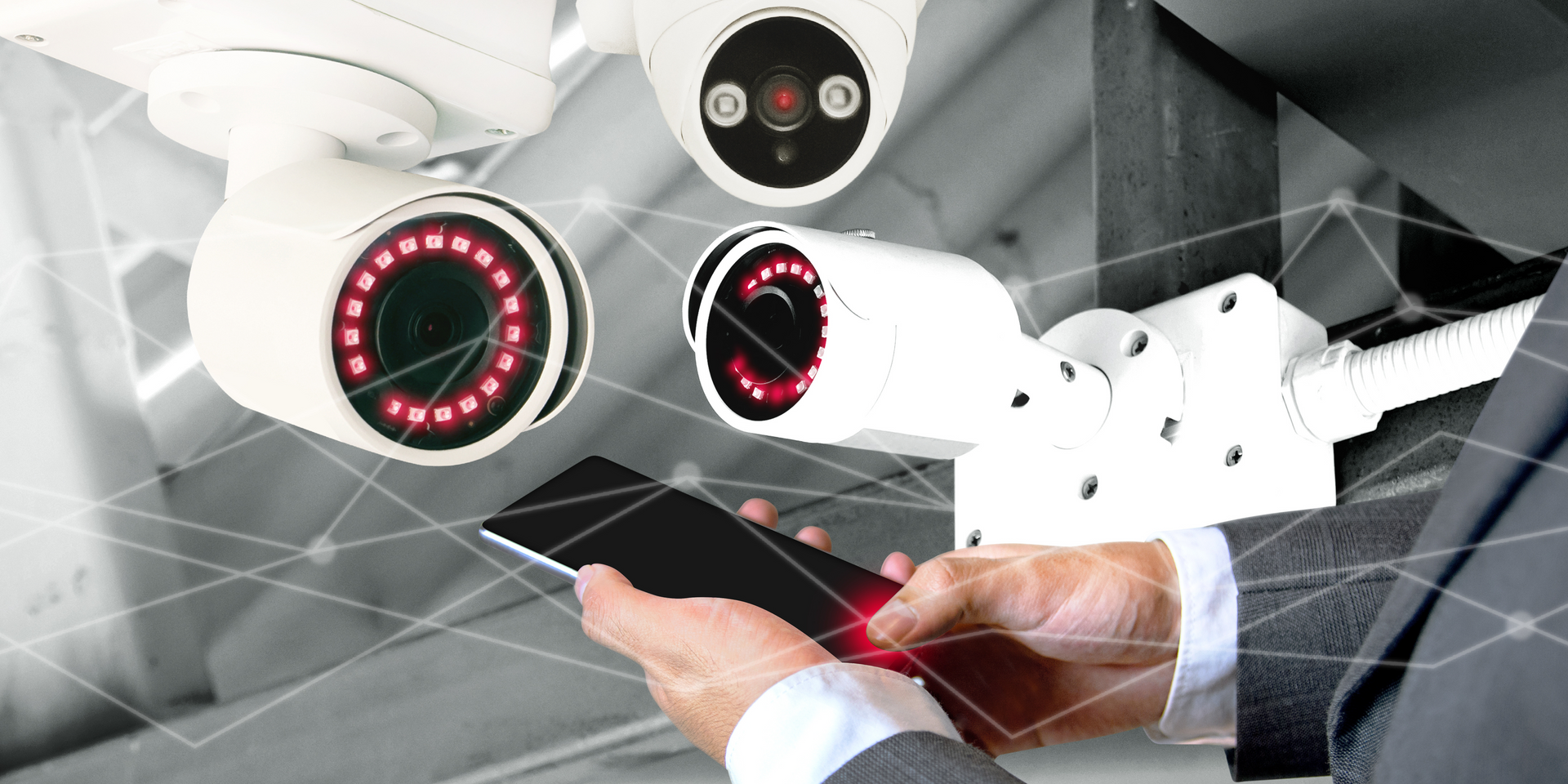 business security cameras and a man holding a phone