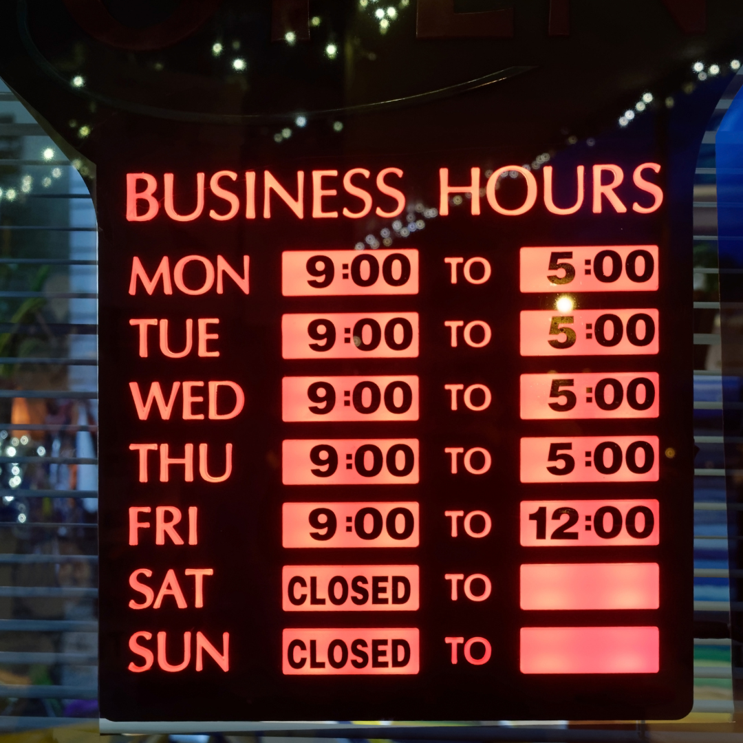 Business hours sign: red lettering, shows hours for each day, with Saturday and Sunday closed.