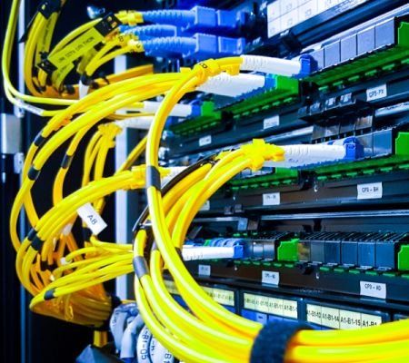a bunch of yellow wires are connected to a server