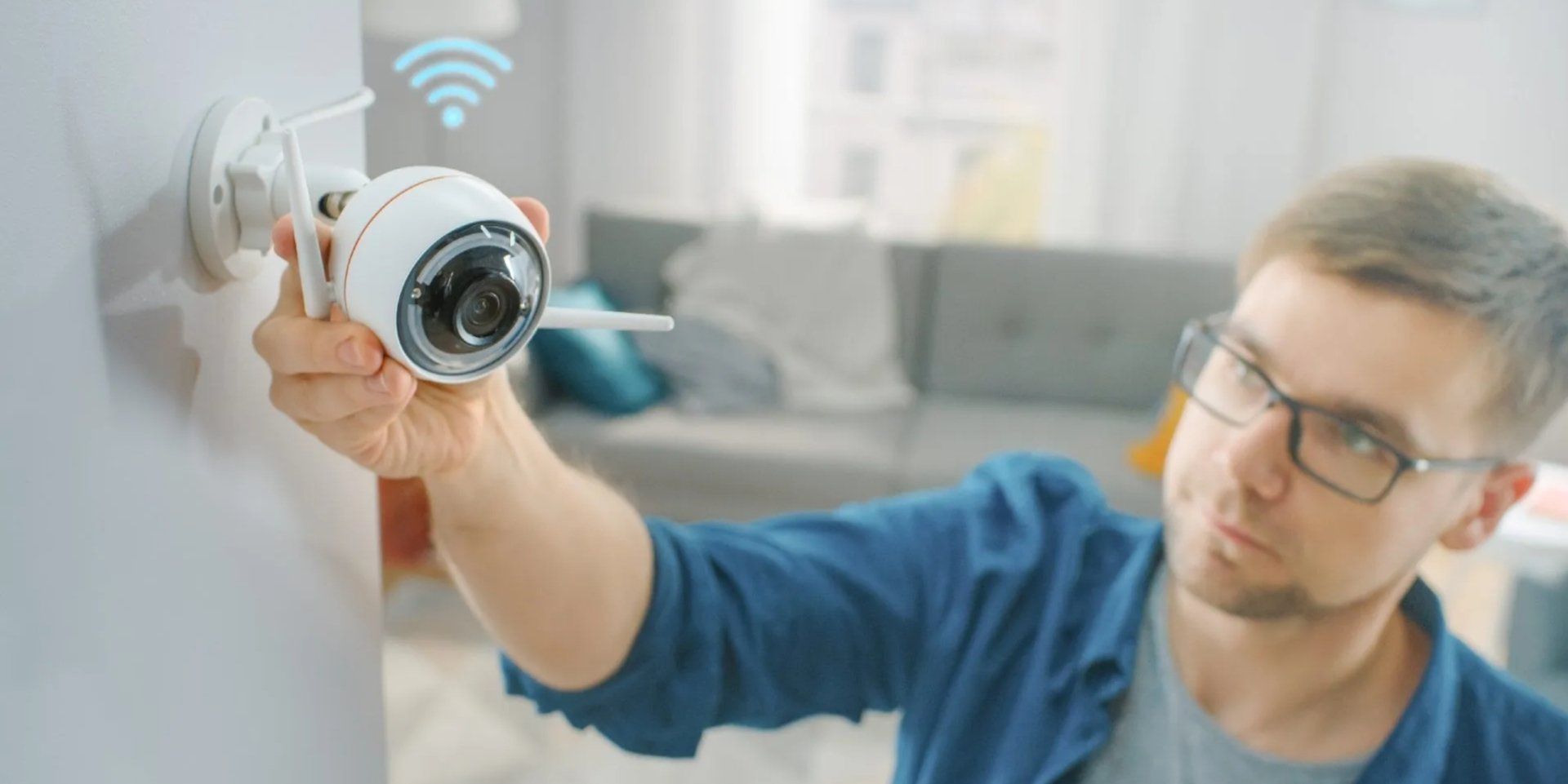 man adjust home video security camera