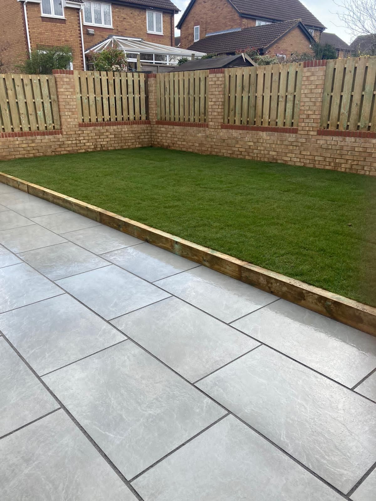 Stunning new porcelain paving patio installation with new turf and new fencing in Hemel Hempstead