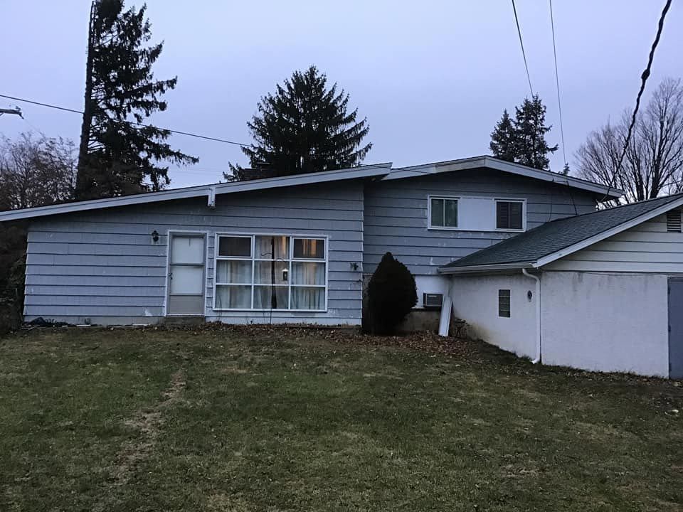 a house with a lot of windows and a garage