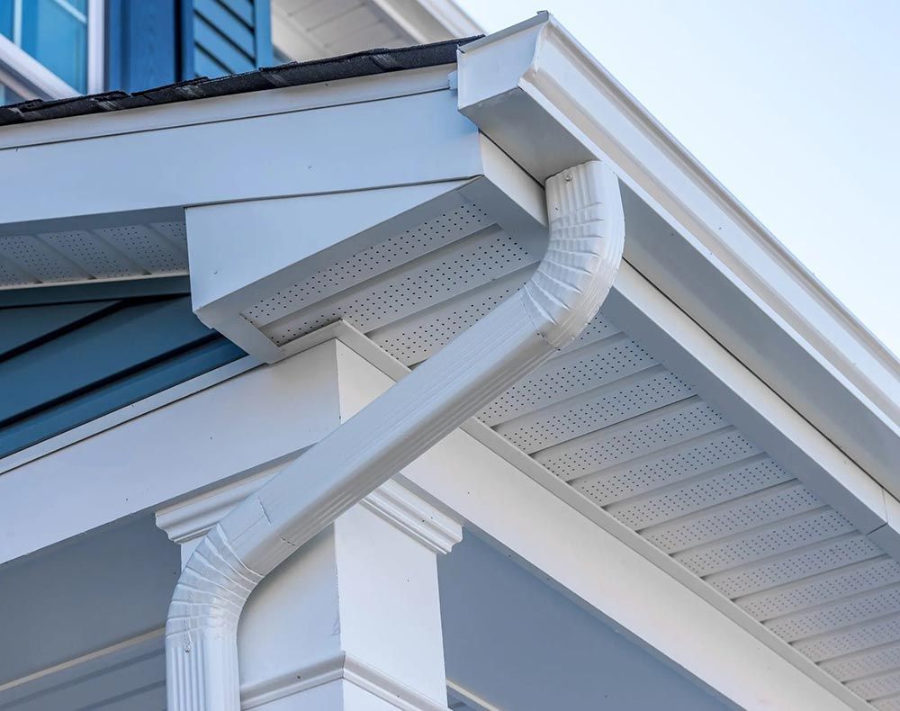 a close up of a white gutter on the side of a house .
