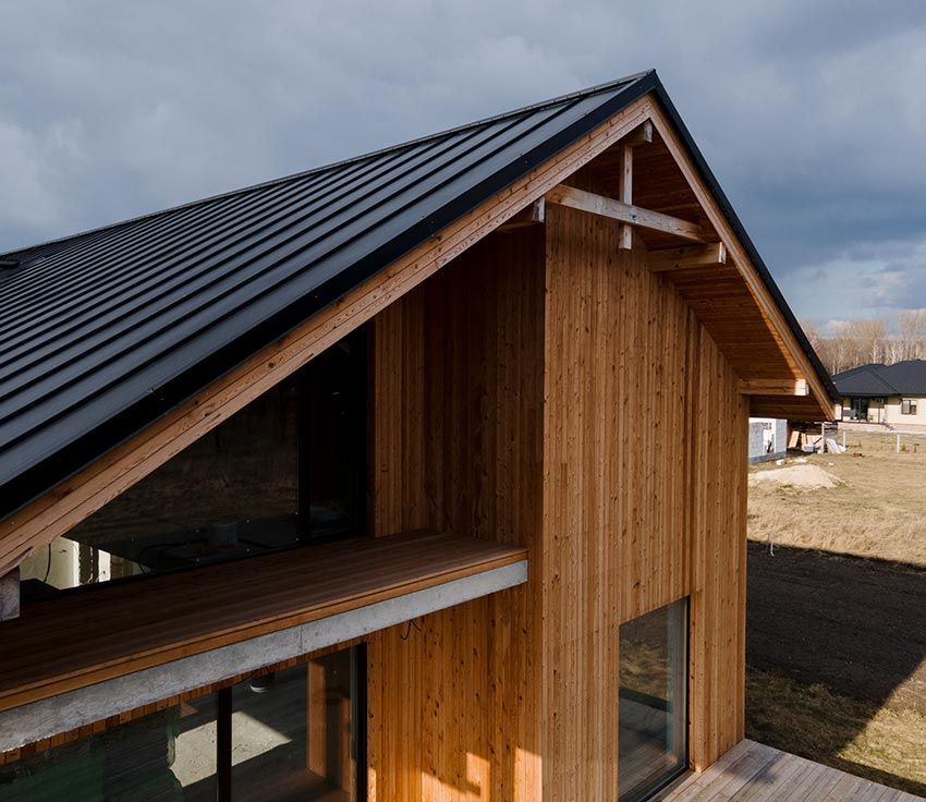 a large wooden house with a black roof