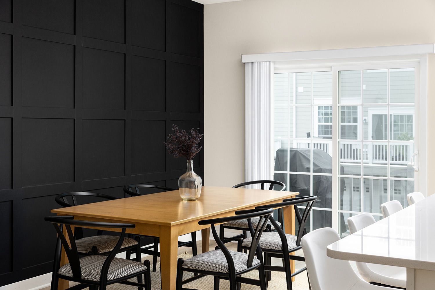 Dining room with black panel accent wall