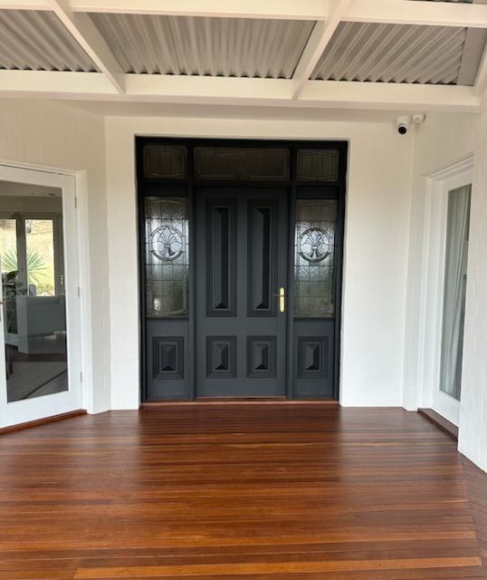 An Empty Room With a Black Door and a Wooden Floor — Skyline Painting In Lavington, NSW