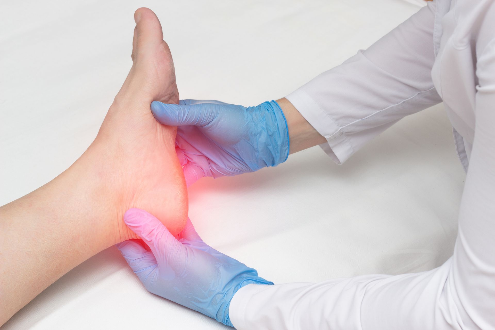A foot doctor examining heel pain during a checkup.