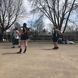 People playing a sport outdoors on a sunny day.