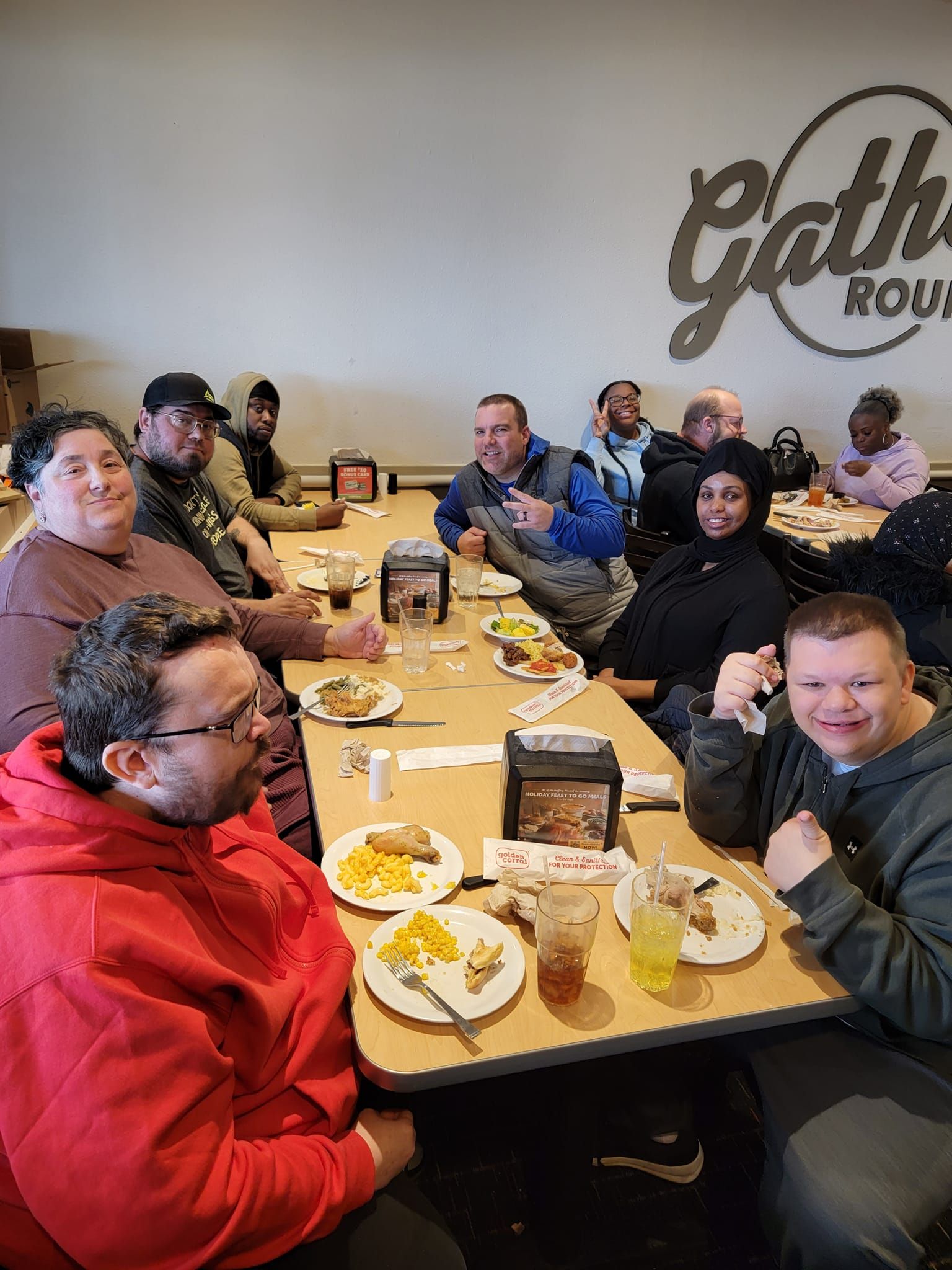 People seated at tables eating at a restaurant called 