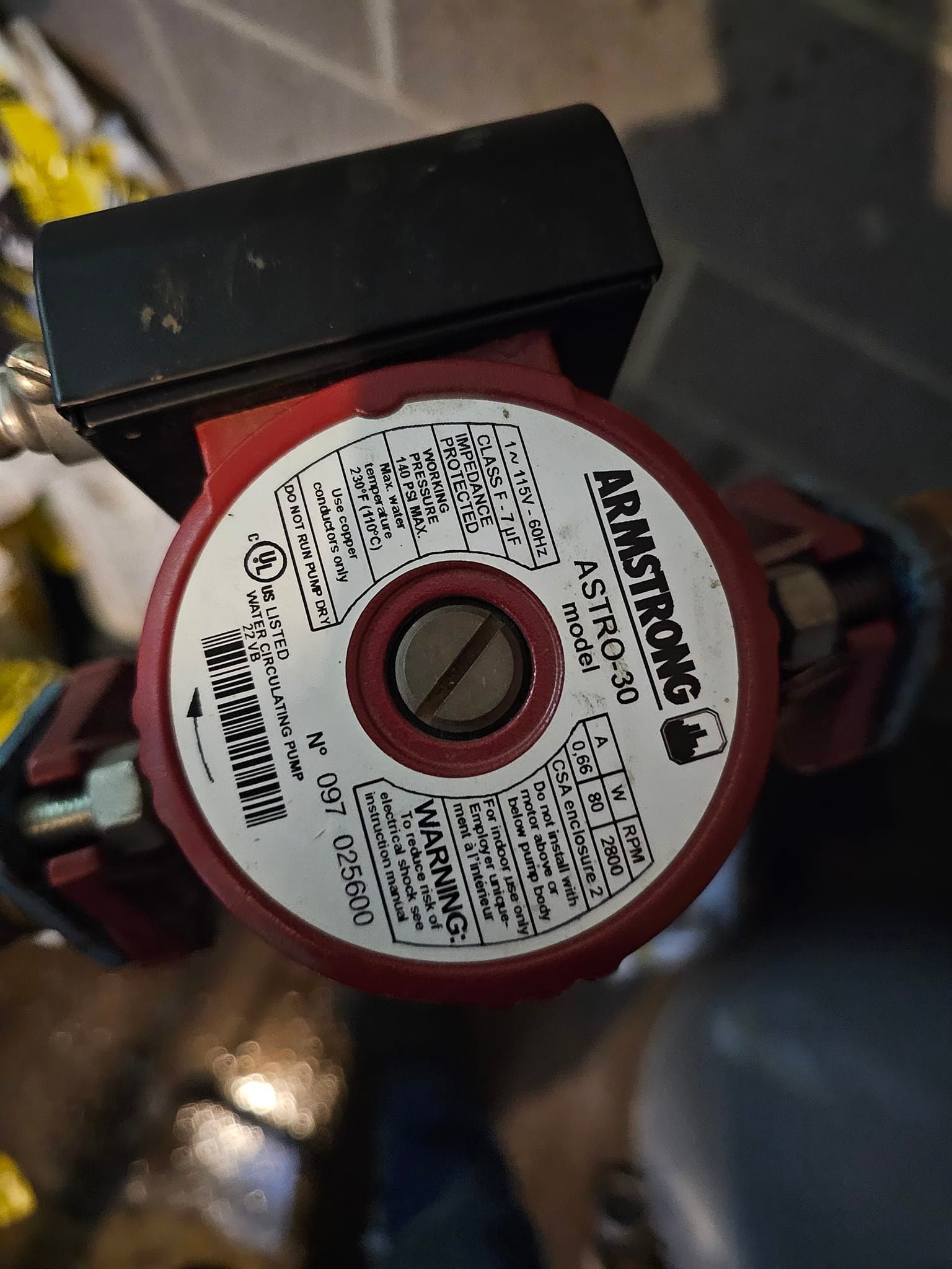 A red and white water pump with a label that says armstrong