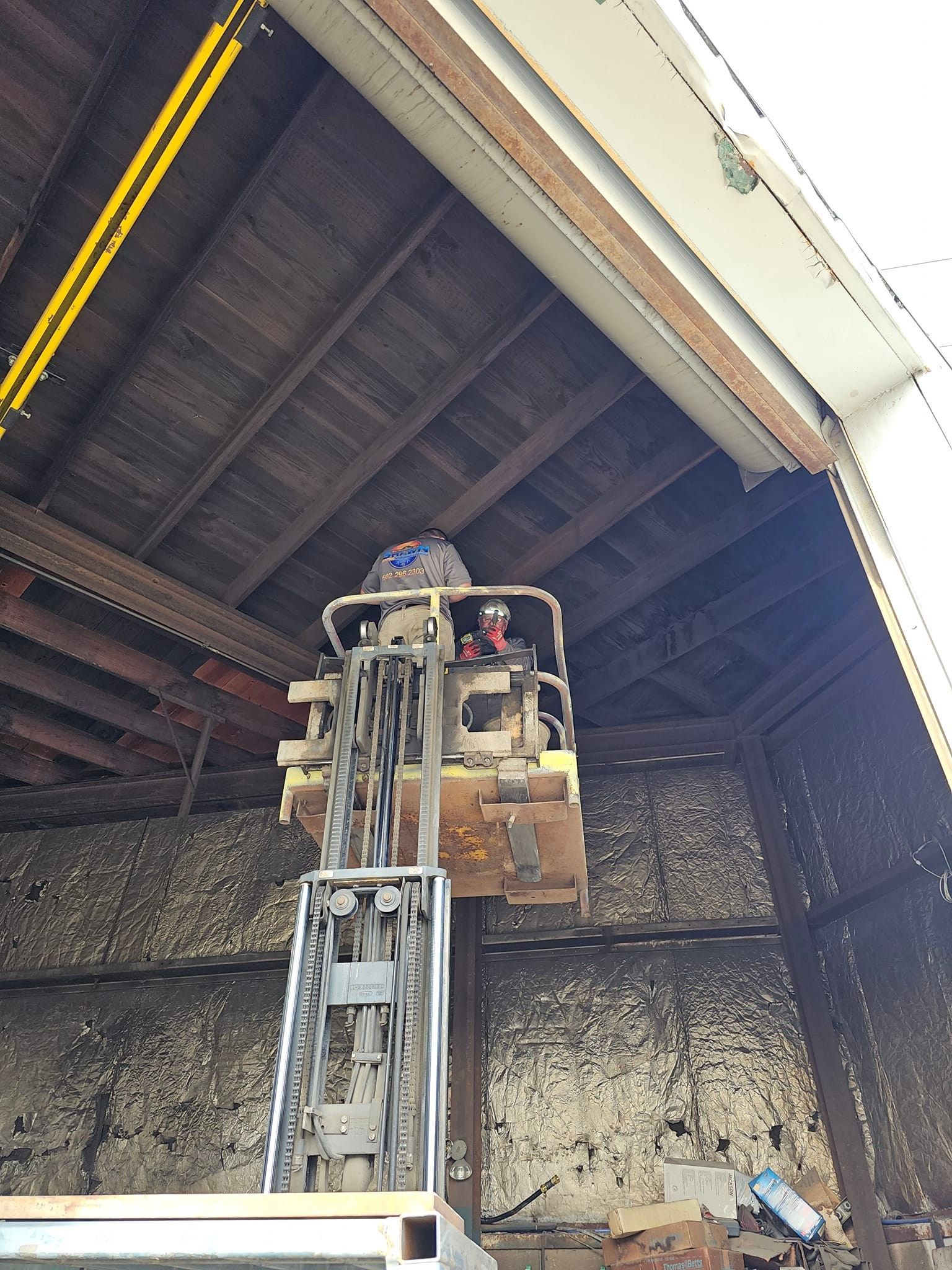 A man is sitting on a lift in a building
