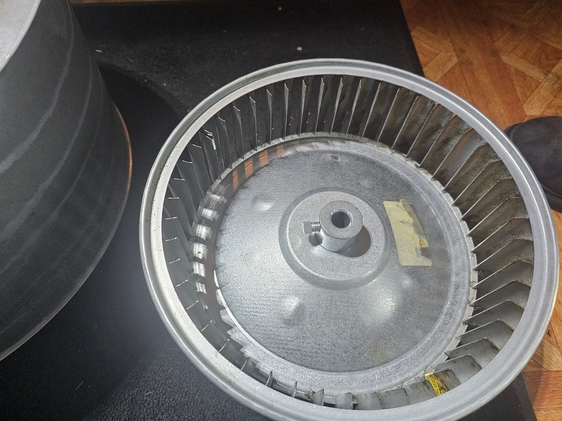 A close up of a metal fan with a hole in the middle