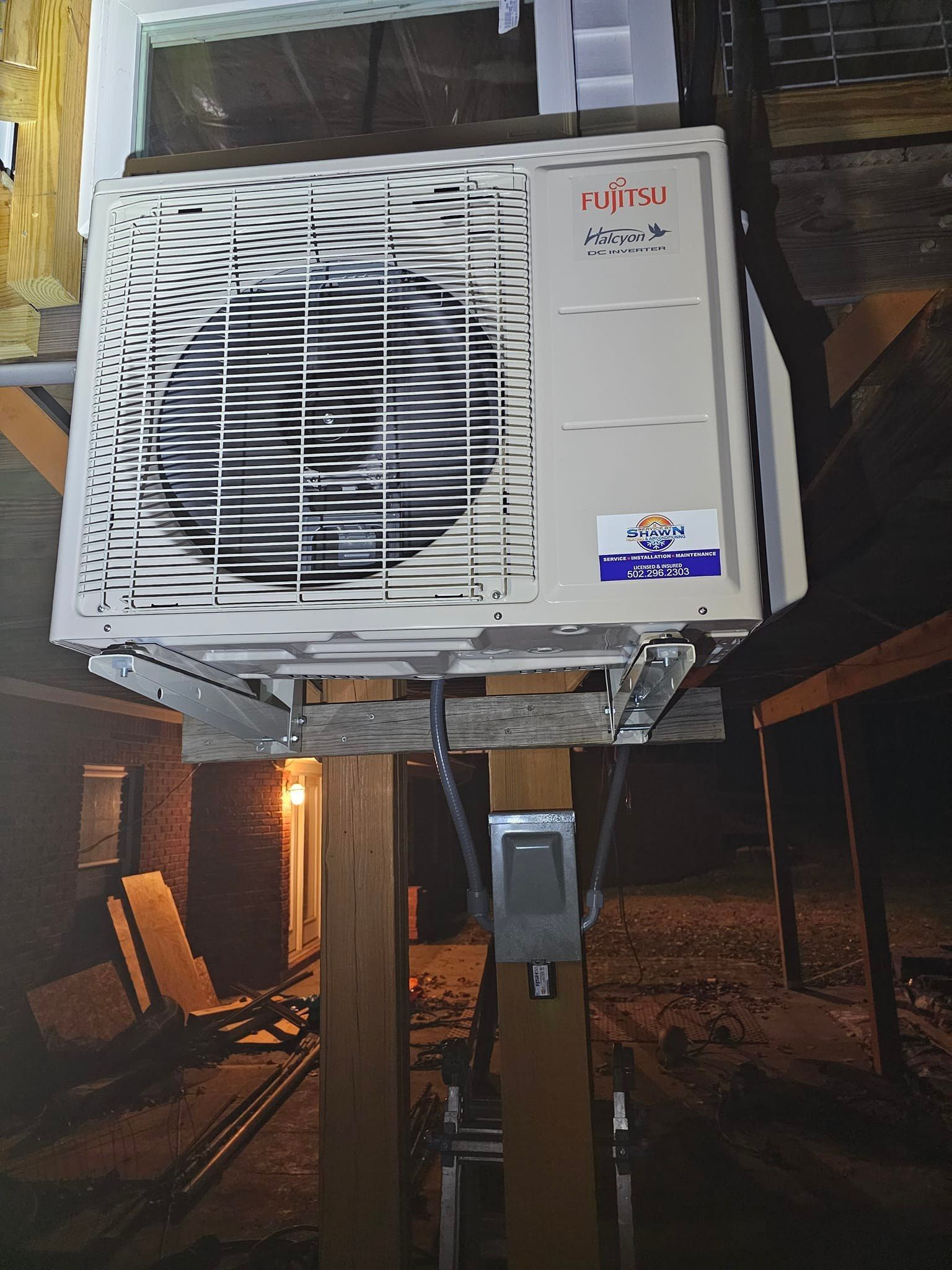 A white air conditioner with a blue sticker that says ' mitsubishi ' on it