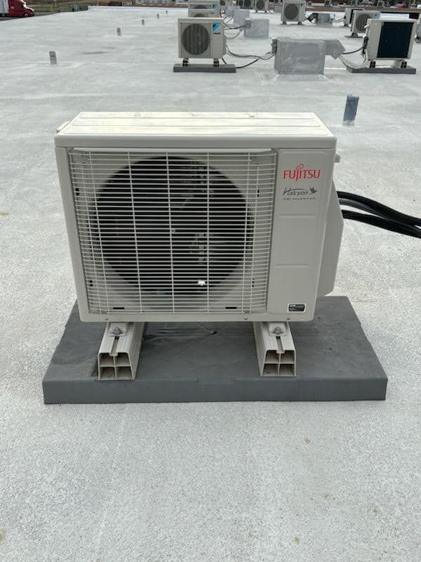 A fujitsu air conditioner is on the roof of a building