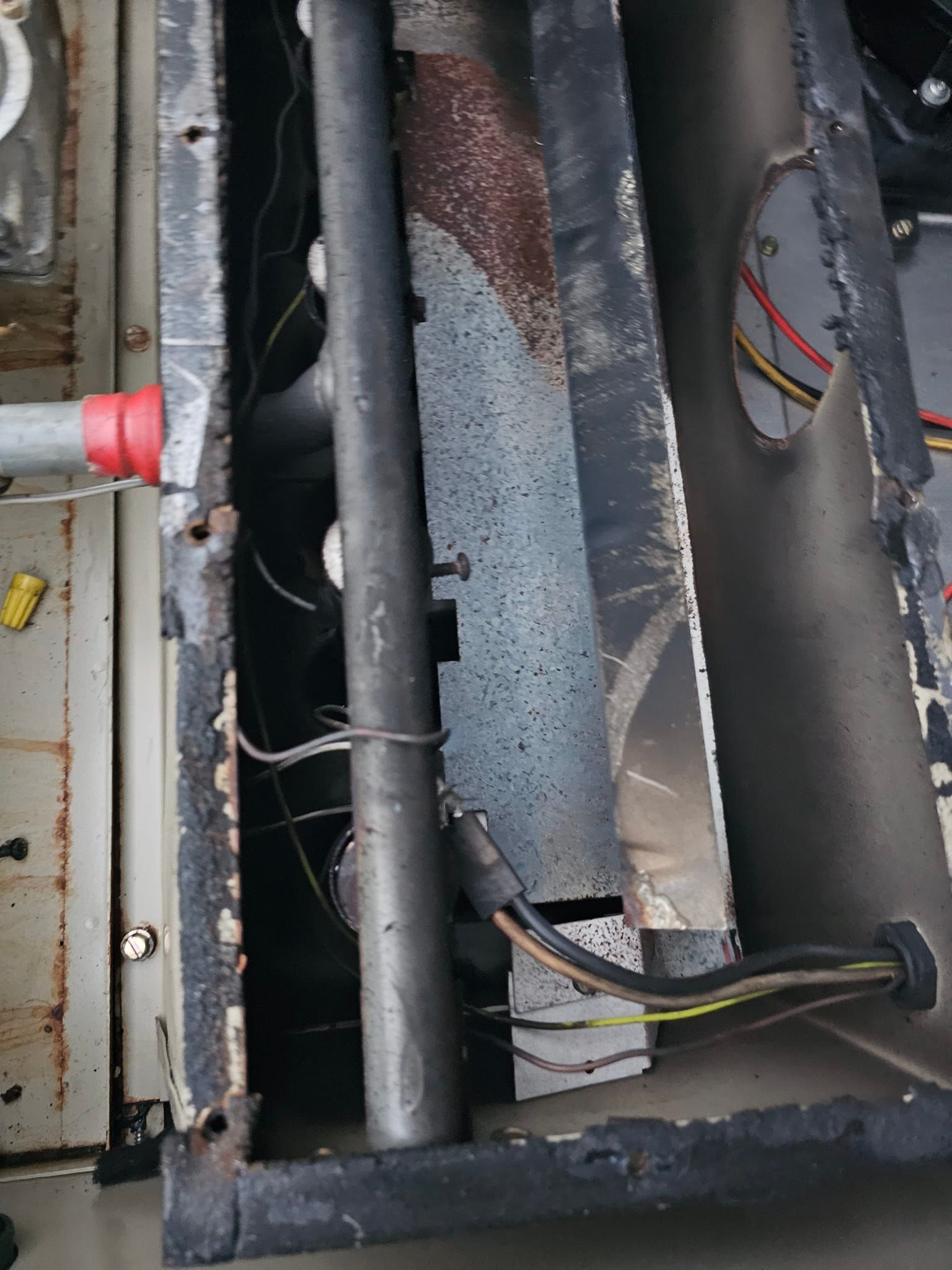 A close up of a metal pipe with wires coming out of it.