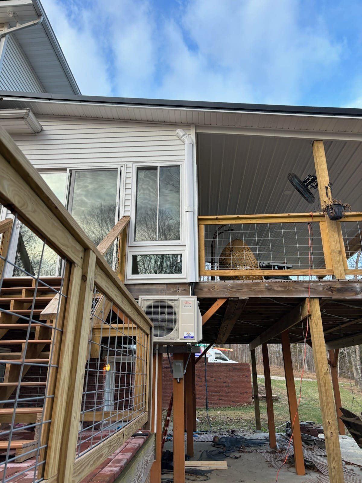 The back of a house with a deck and stairs.