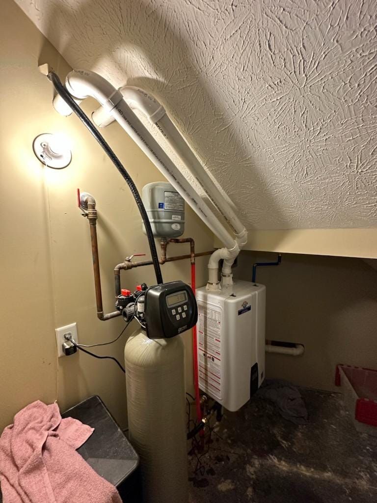There is a water heater in the corner of the room.