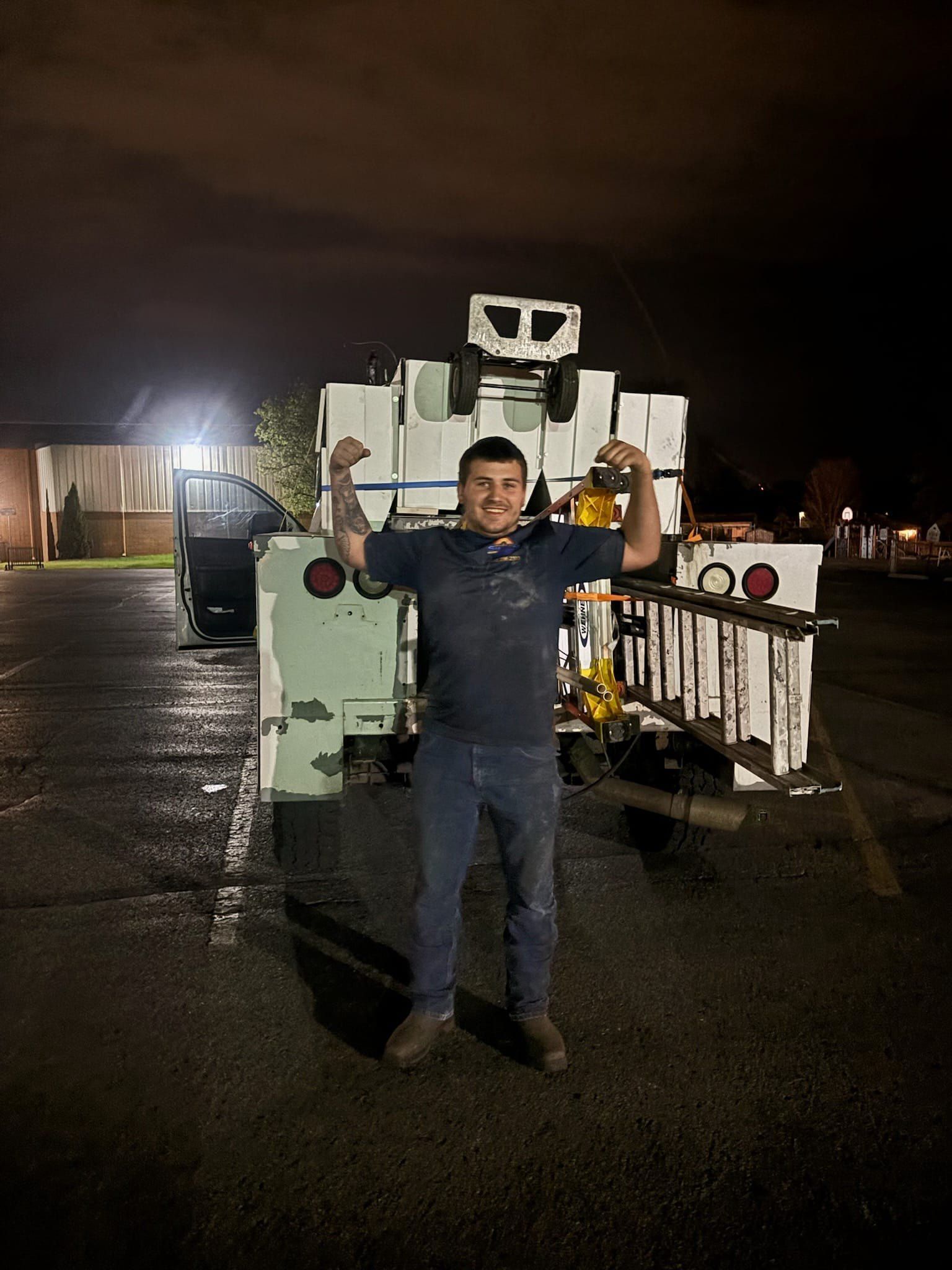 A man is standing in front of a truck that looks like a robot.