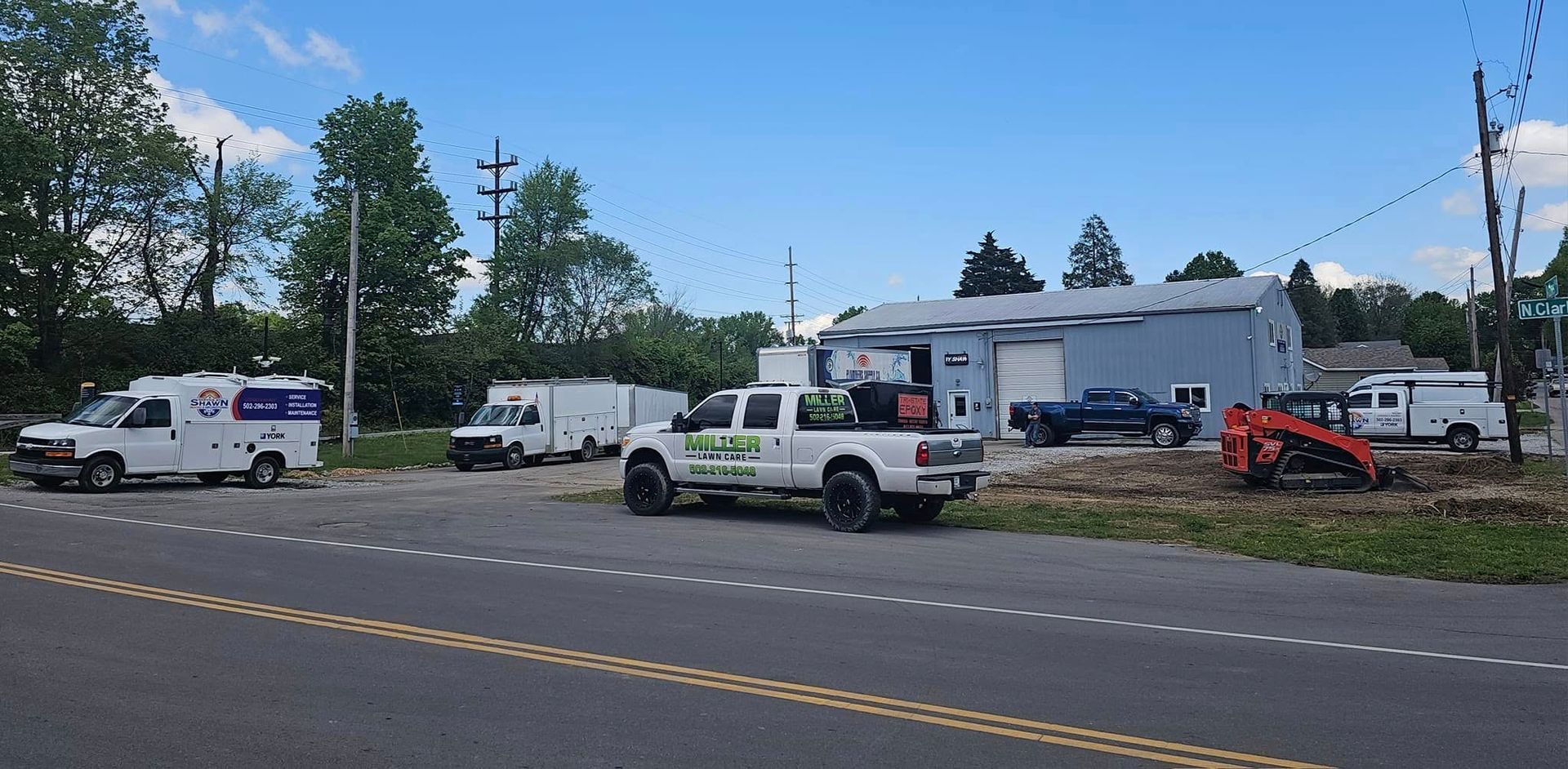 A truck is parked on the side of the road in front of a building.