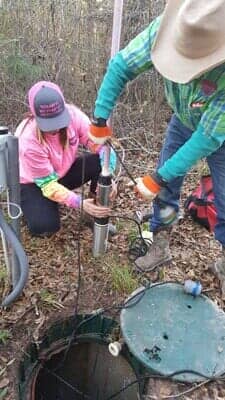 Worker Emptying Septic — Septic Tank in Cleveland, TX Worker Emptying Septic — Septic Tank in Cleveland, TX