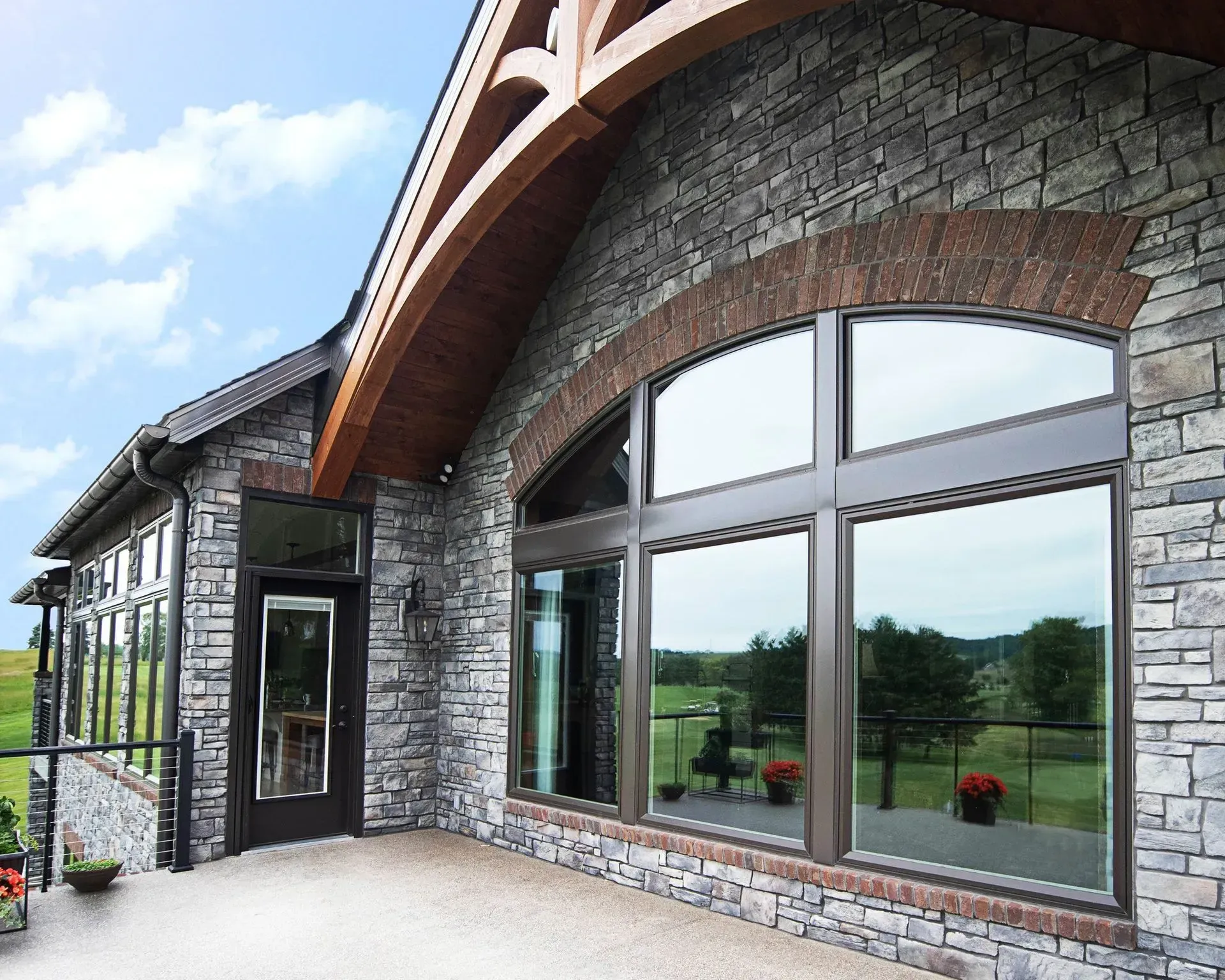A bathroom with a tub and a window with trees in the background
