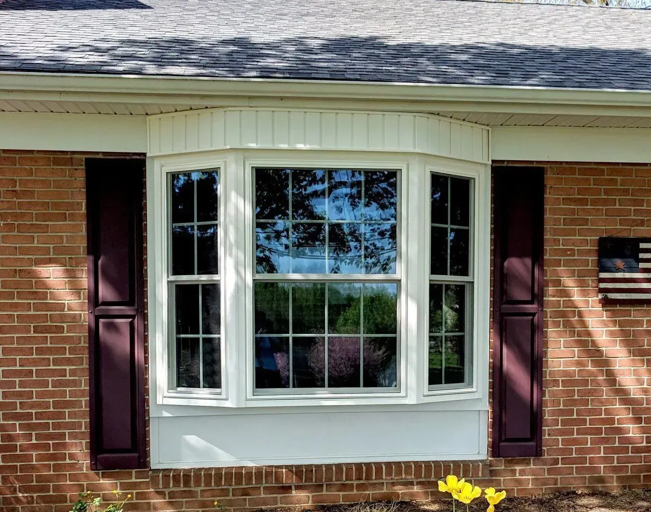 A living room with a large window and a chair