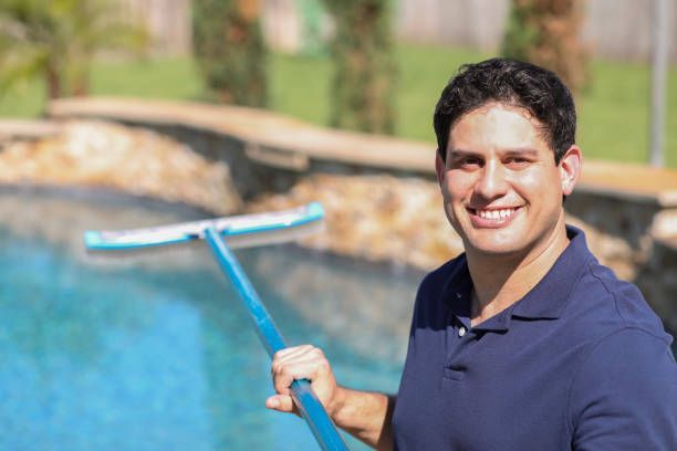 Heritage Pool Plastering's repairman provides Residential Spa Repair in Las Vegas, also seen as a cleaning service man at a home pool.