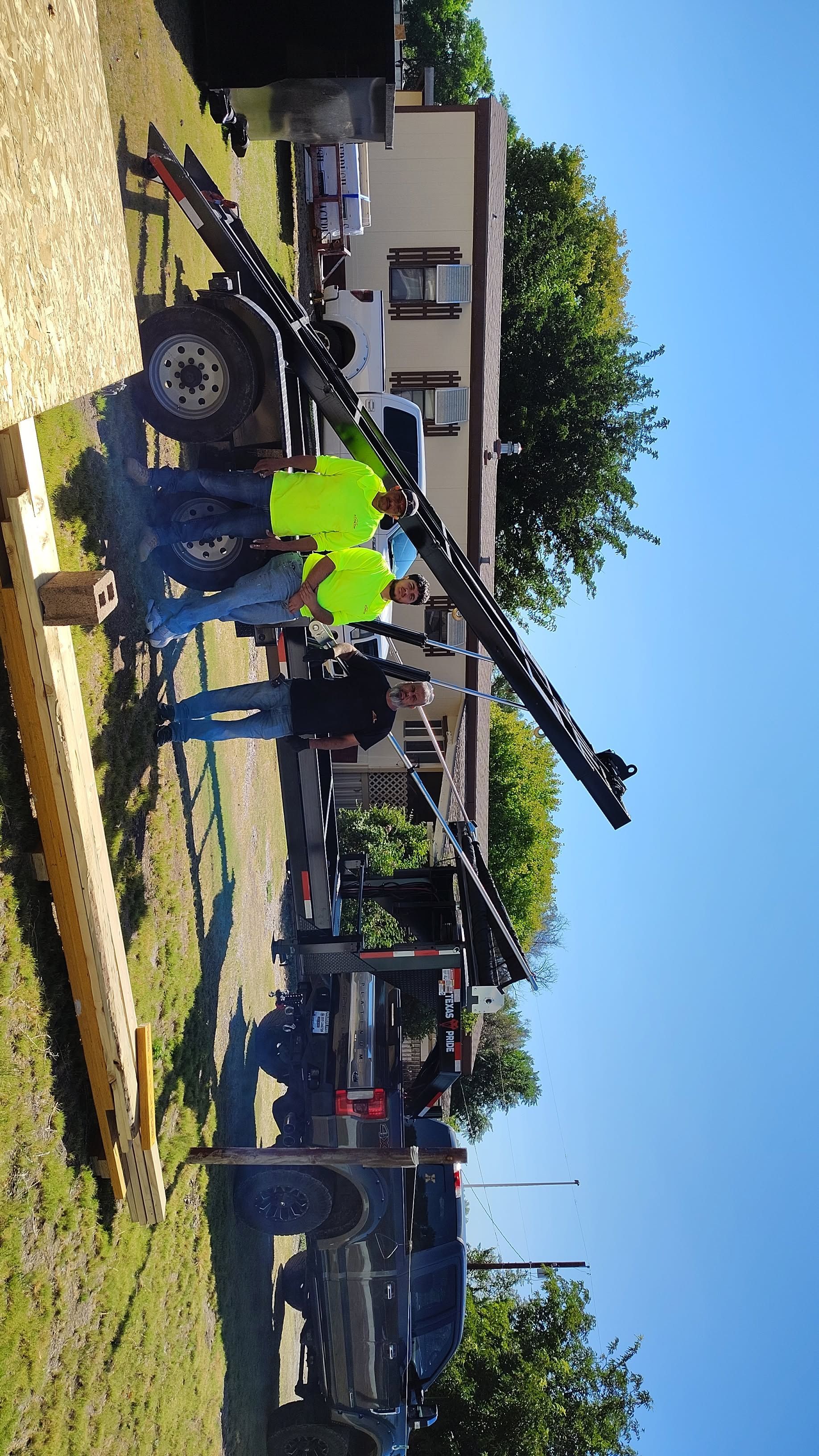 A white truck is parked in a parking lot next to a building.