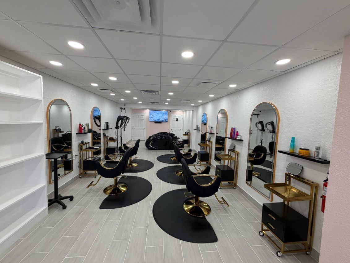Bathroom with a tan sink, toilet, and tile floor. White walls with a decorative border.
