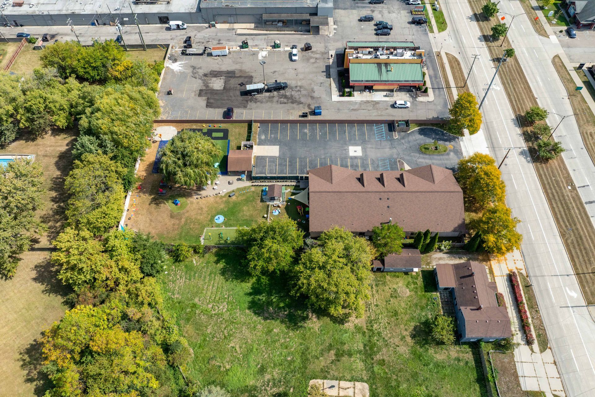 Aerial view of buildings, trees, and a road.