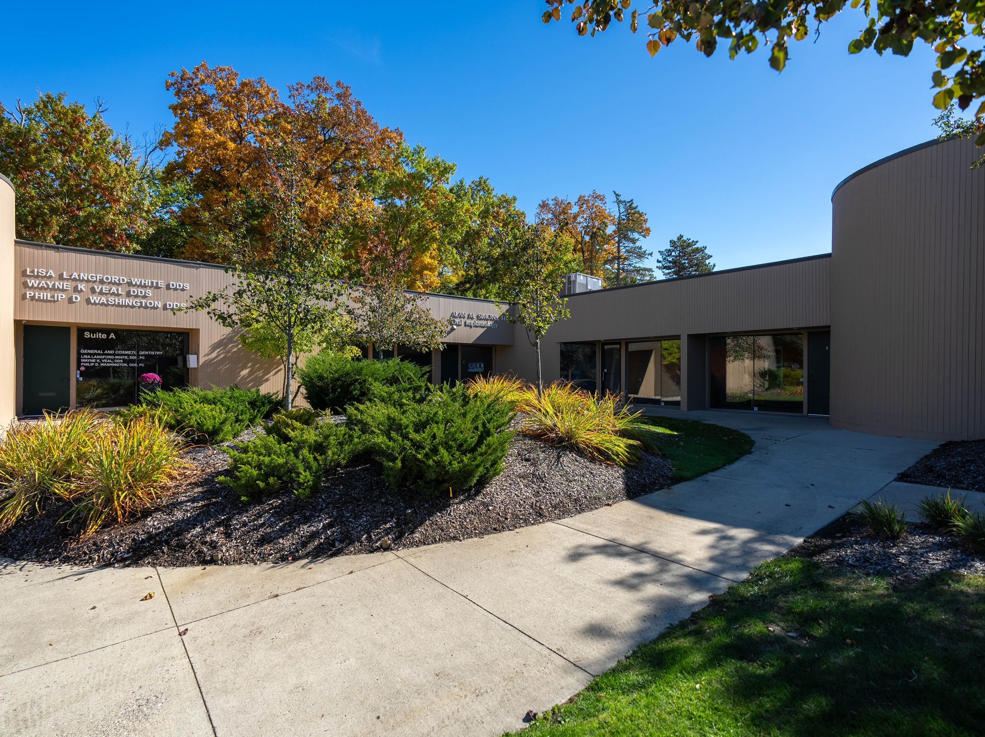 Brown building with landscaping and blue sky, likely an office or medical facility.