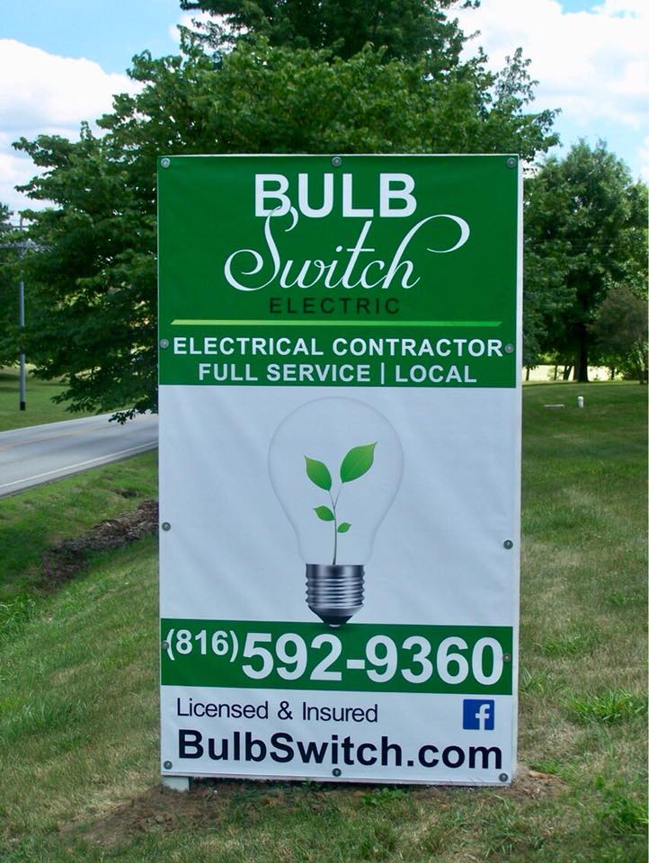A green and white sign for bulb switch electric