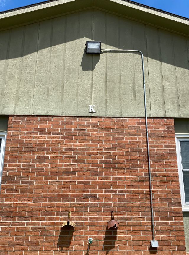 A brick wall with a light on top of it