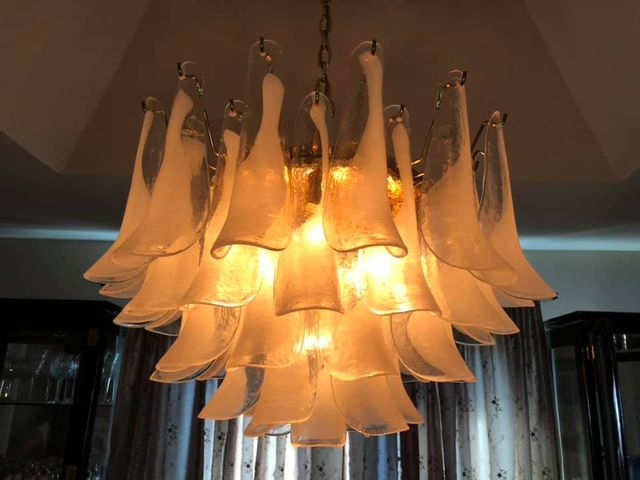 A chandelier is hanging from the ceiling in a dark room.