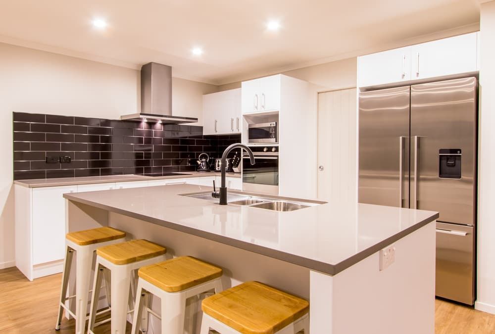 A Kitchen with A Large Island a Refrigerator and A Sink — Top End Joinery In Yarrawonga, NT