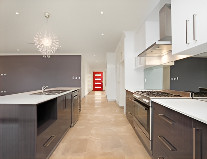 A Kitchen With Stainless Steel Appliances and a Red Door — Top End Joinery In Yarrawonga, NT
