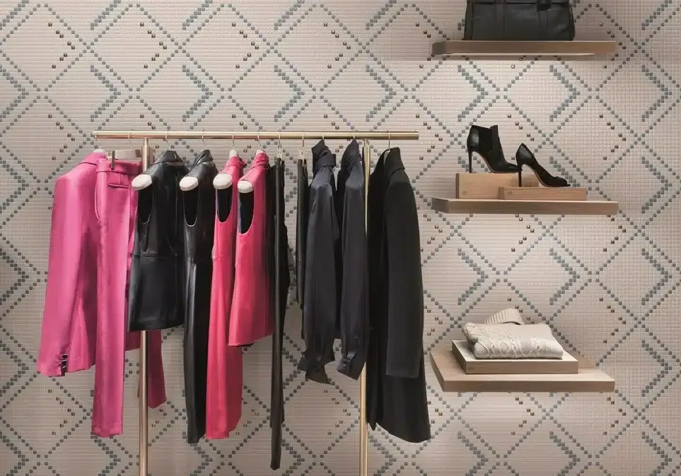 Una fila di vestiti appesi su uno scaffale in un negozio.