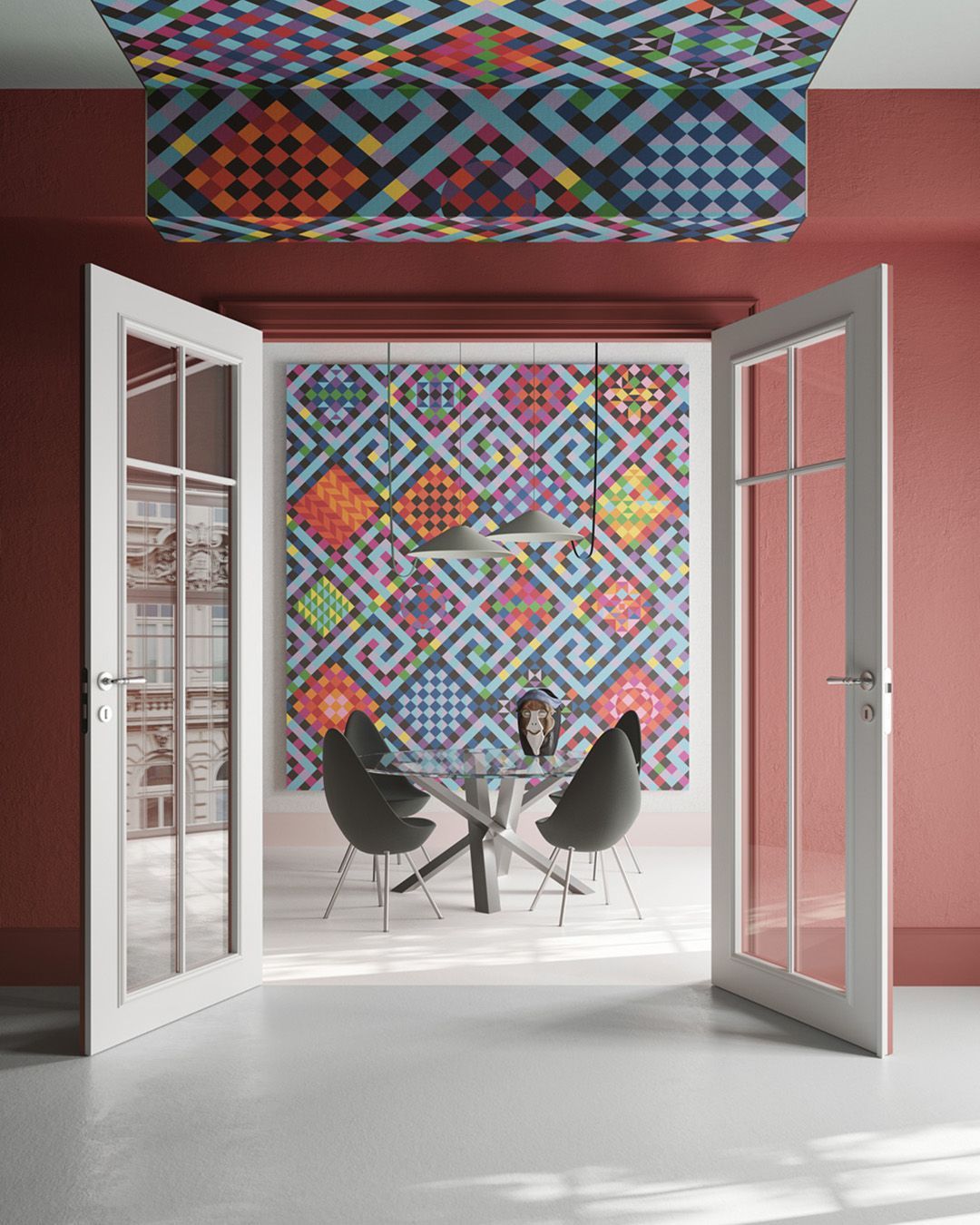 Una donna è seduta a un tavolo in una stanza con un motivo colorato sulla parete.