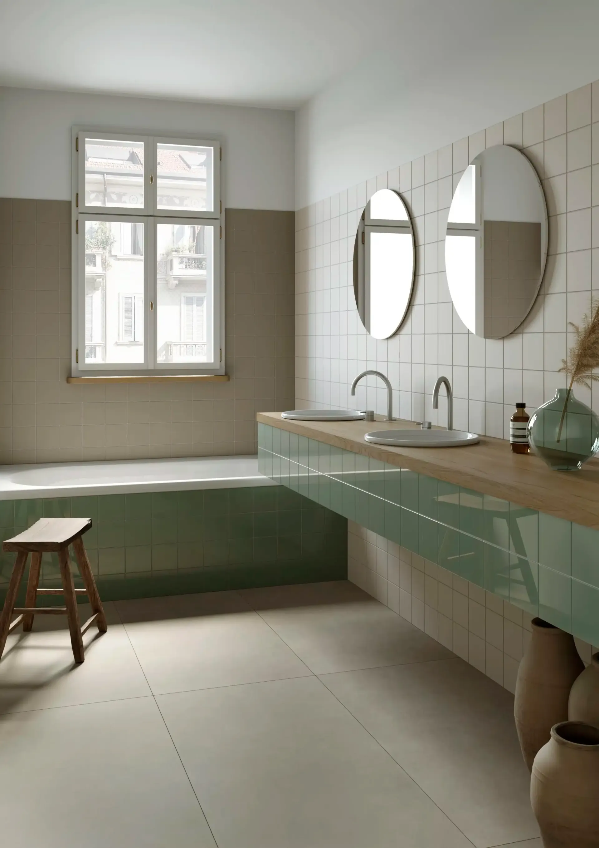 Un bagno con due lavandini, una vasca e due specchi.