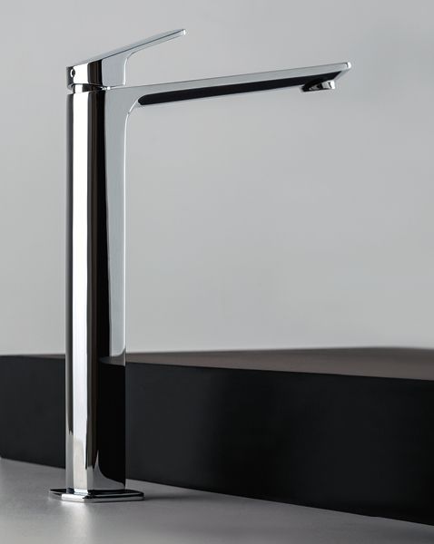 Un alto rubinetto cromato è appoggiato su un bancone.