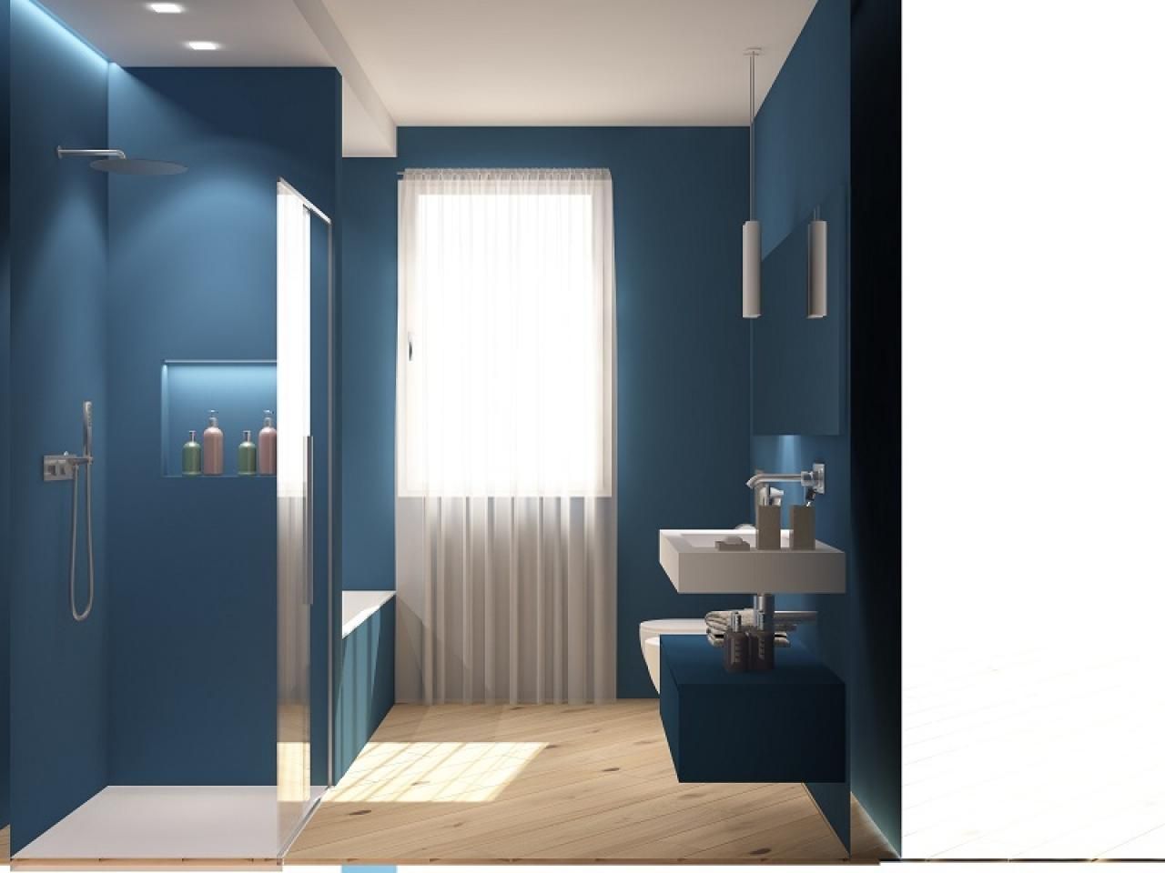 Un bagno con pareti blu e un lavandino bianco